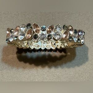 Gold stretch bracelet featuring clear, grey, and peach crystals​